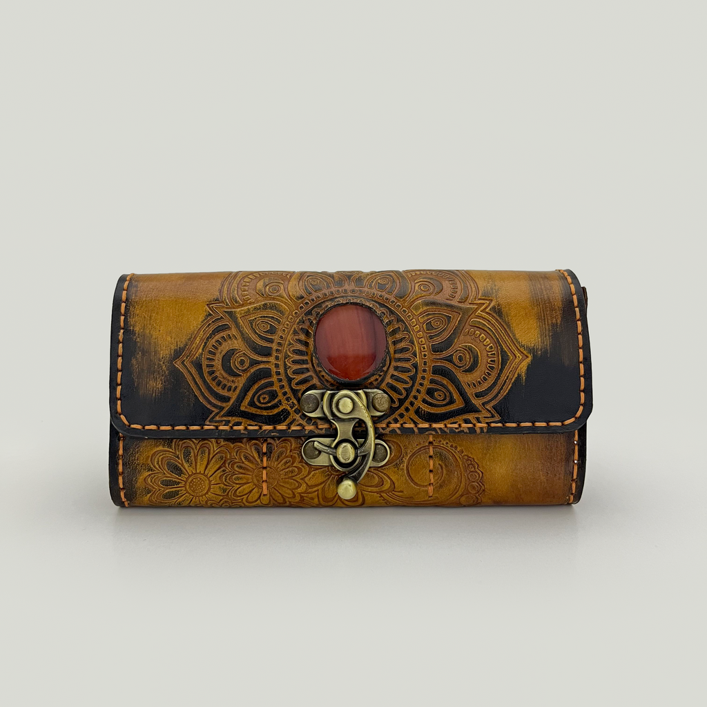 Purple wallet with gold embossed design on a light gray background