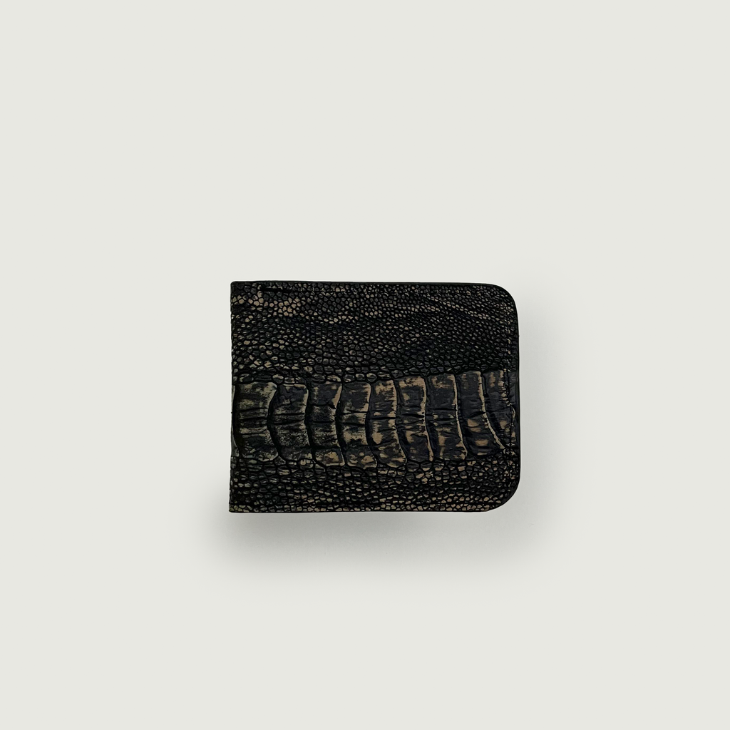 A dark crocodile-textured wallet is centered against a light gray background. The texture suggests luxury and sophistication, conveying a sense of elegance.